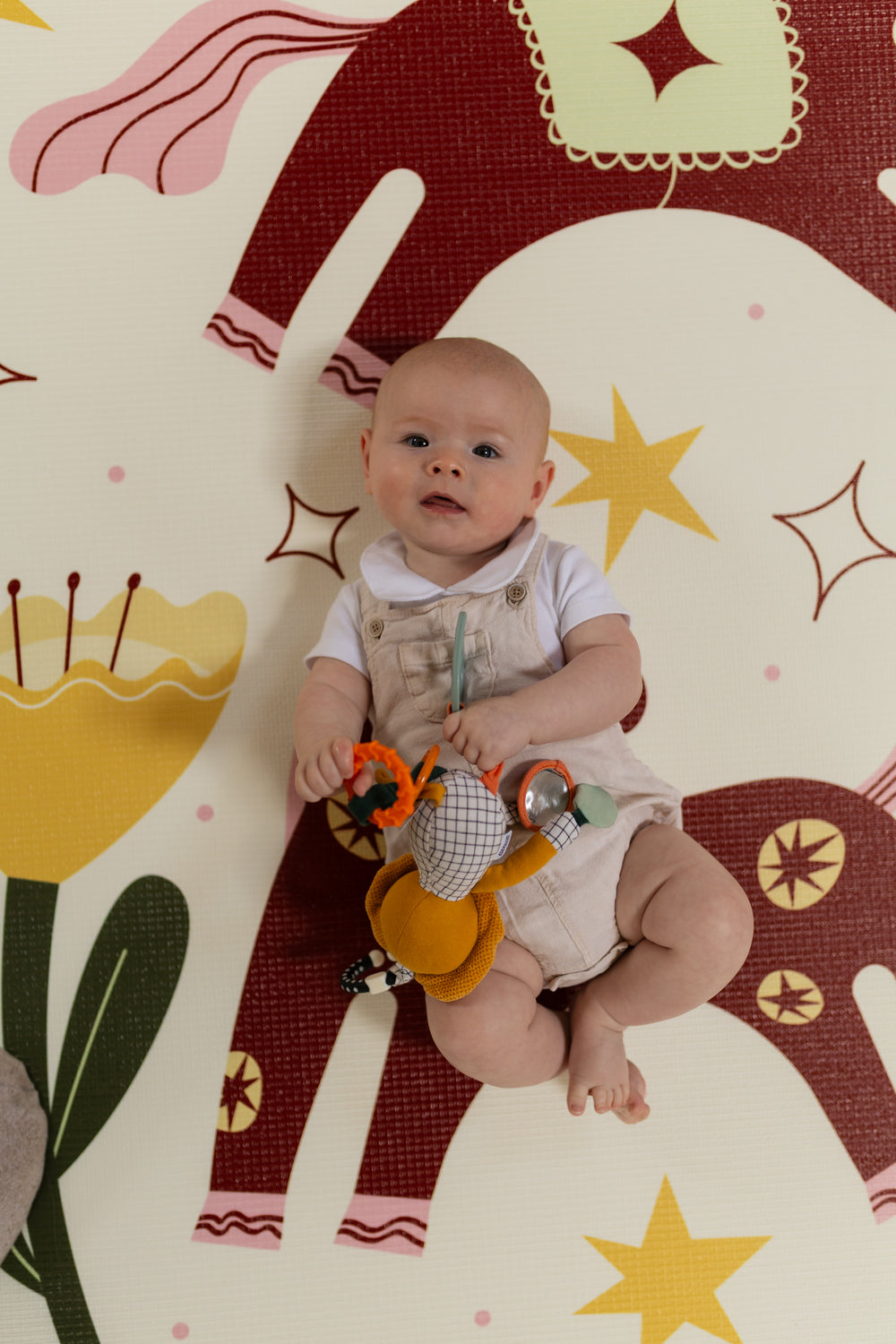 Baby on a colourful playmat
