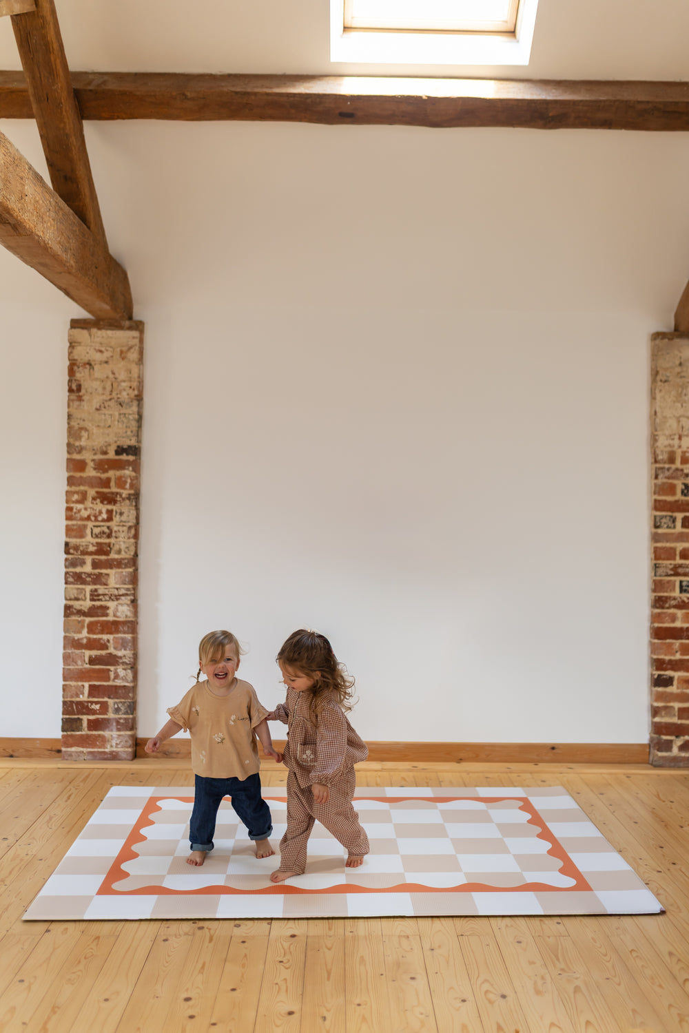 Little giggles girls playing standing on a playmat